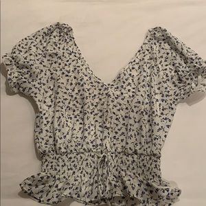 White and blue flower blouse with singed bottom